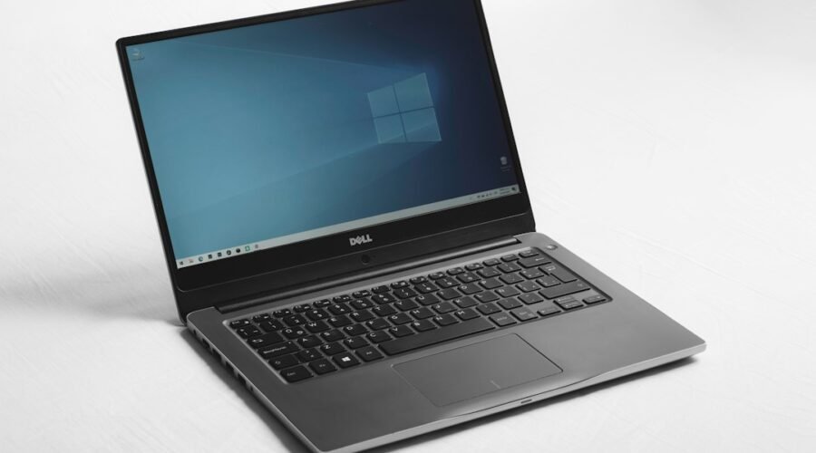 Laptop showing a blue Windows desktop, illustrating the Windows 11 26H2 update